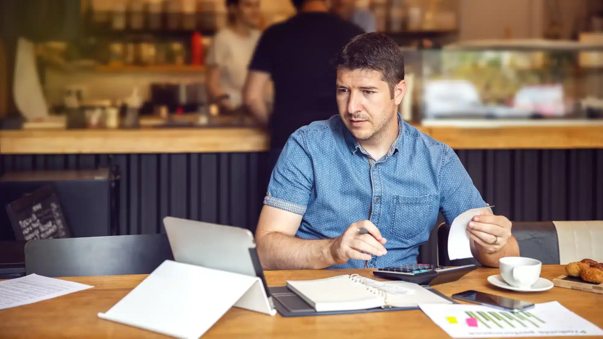 Entrepreneur in Georgia reviewing PCS Loan documents while preparing for a business funding application.