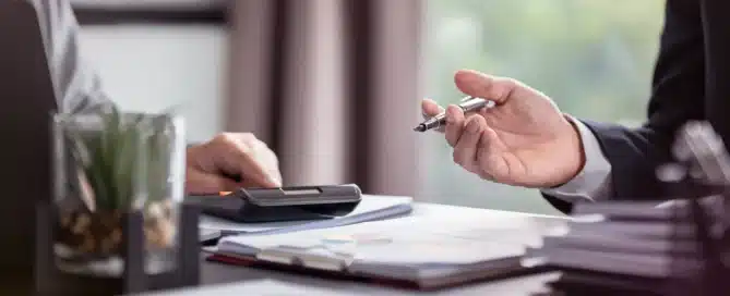 Business owner completing an online application for a business line of credit in California with financial documents and approval checklist