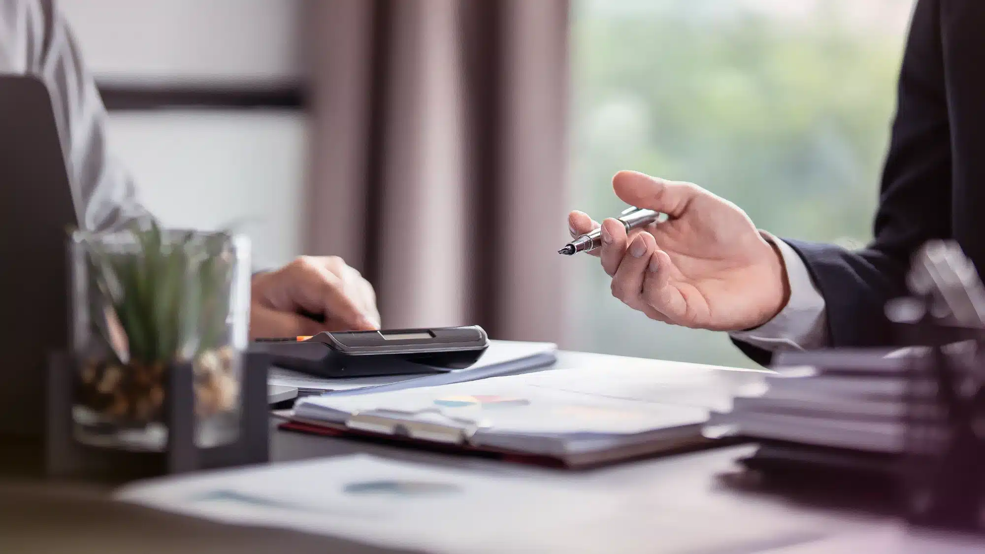 Business owner completing an online application for a business line of credit in California with financial documents and approval checklist