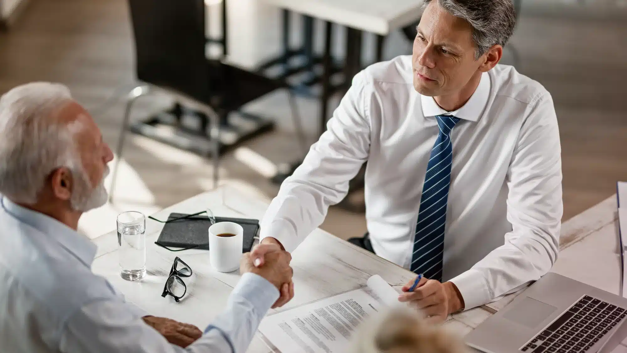 Business owner meeting with a lender to discuss business acquisition loans, financing requirements, loan benefits, and the application process.